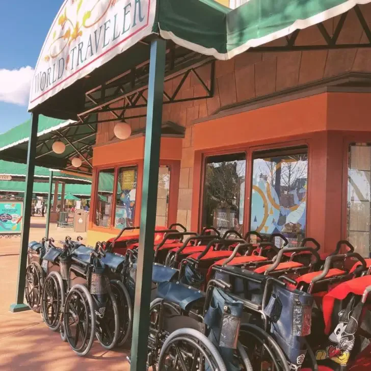 Photo of strollers and wheelchairs lined up outside the World Traveler gift shop at Epcot theme park.