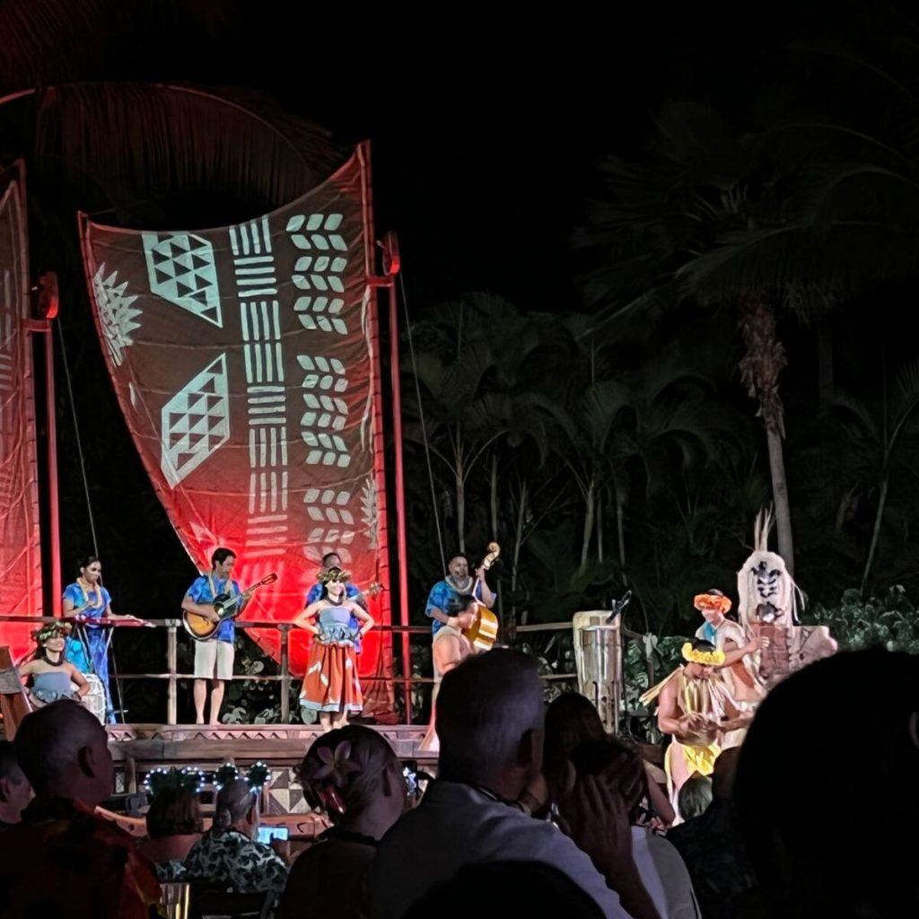 Photo of musicians and dancers on stage at the Ka Wa'a Luau.