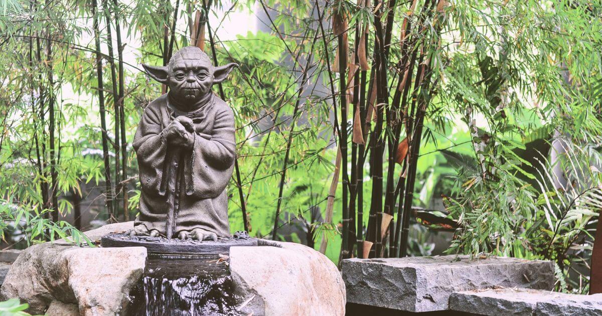 Photo of a Yoda statue in a bamboo garden in Singapore.