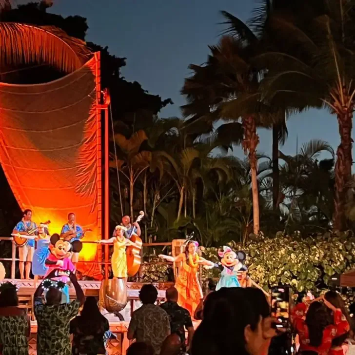 Photo of musicians, dancers, and Mickey and Minnie Mouse on stage at the Disney Aulani Luau.