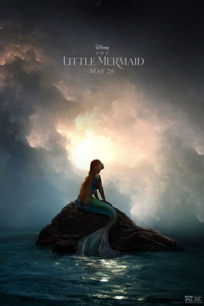 Promotional poster for the 2023 film, The Little Mermaid, featuring Ariel sitting on a rock in the middle of the ocean.