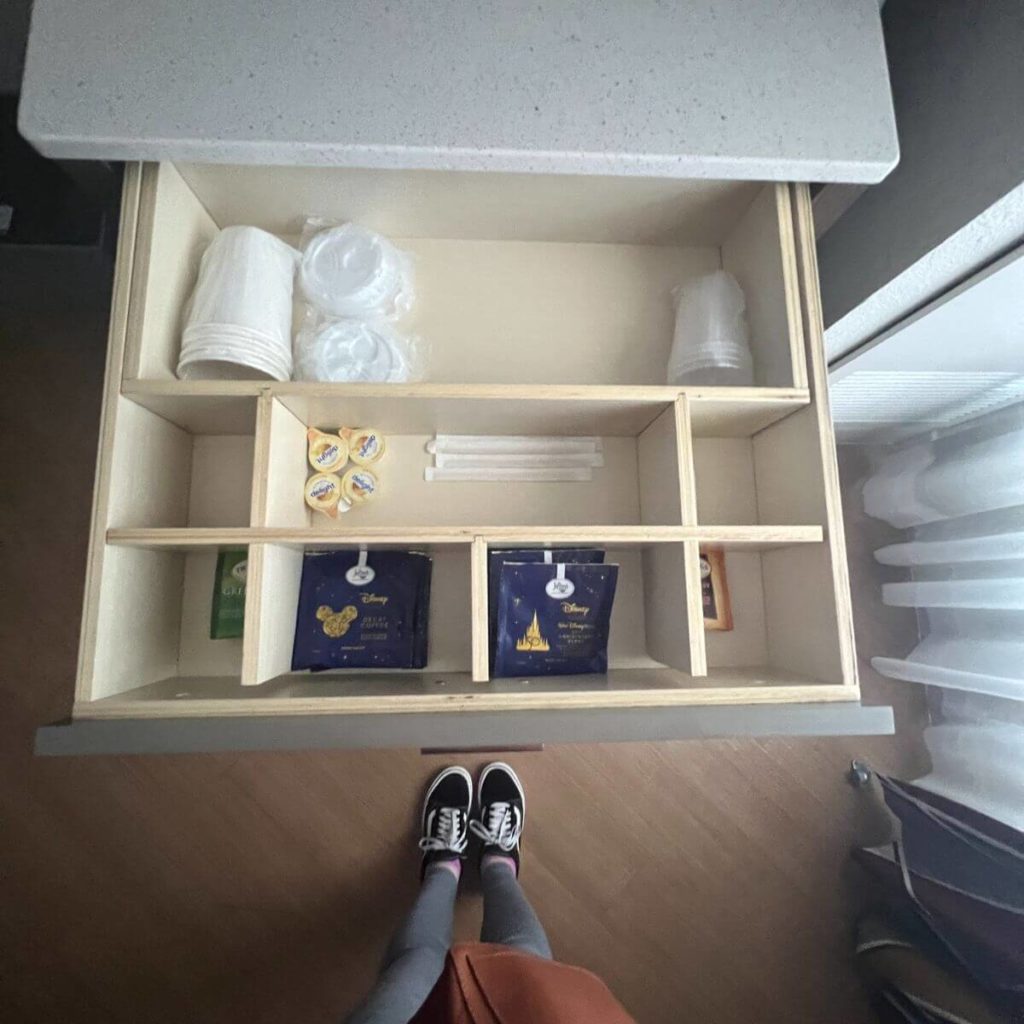Photo of the contents of the drawer from the guest room drink station with coffee and tea sachets, cups, and other necessities.