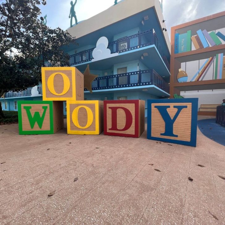 Photo of the Toy Story section at Disney's All-Star Movies Resort with large toy blocks that spell out "Woody" in the foreground.
