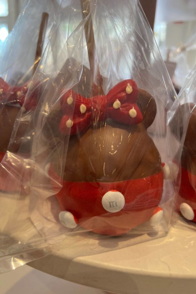 Photo of a Minnie Mouse themed chocolate covered candy apple.