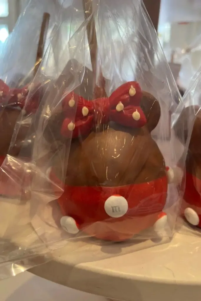 Photo of a Minnie Mouse themed chocolate covered candy apple.