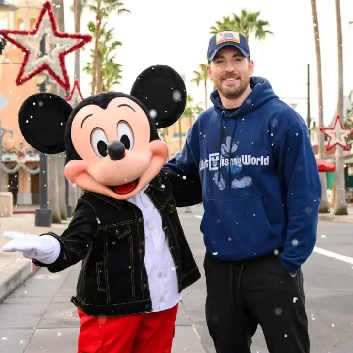 Photo of actor Chris Evans posing with Mickey Mouse at Hollywood Studios.