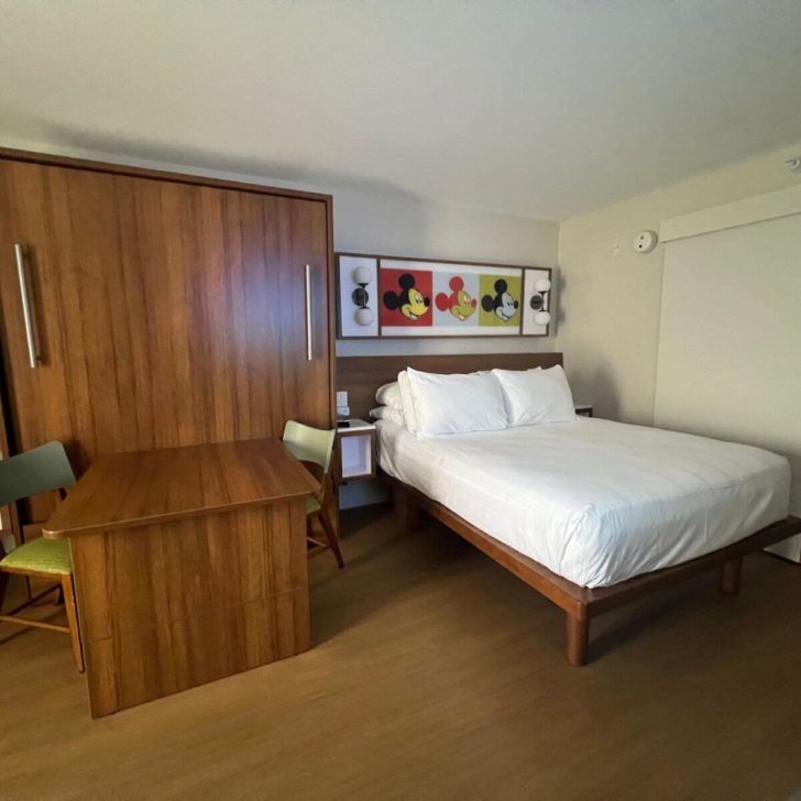 Photo of a typical room at a Disney World value resort, with a Murphy bed on one side and regular bed on the other.