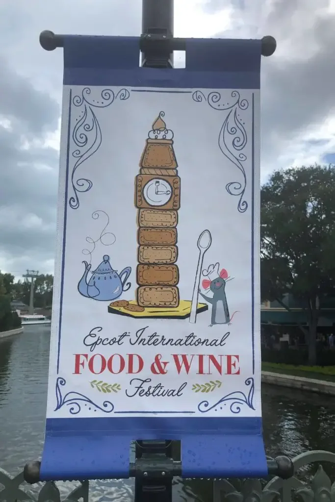 Photo of a sign on a pole at Epcot for the Epcot International Food & Wine Festival.