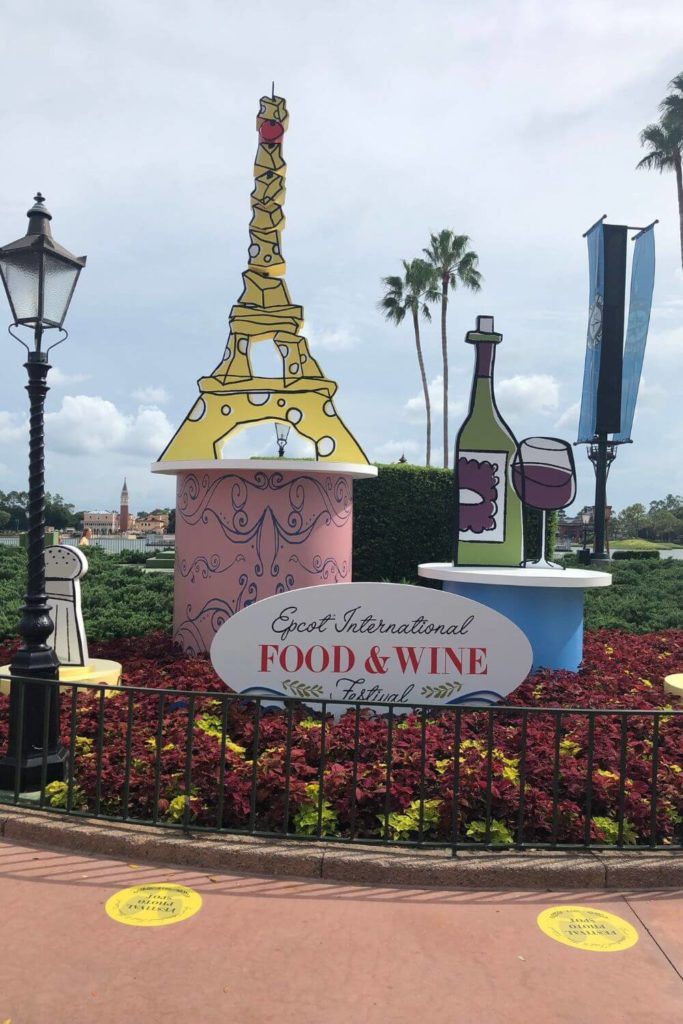 Photo of the floral and art display at the main entrance of Epcot for the Epcot International Food and Wine Festival.