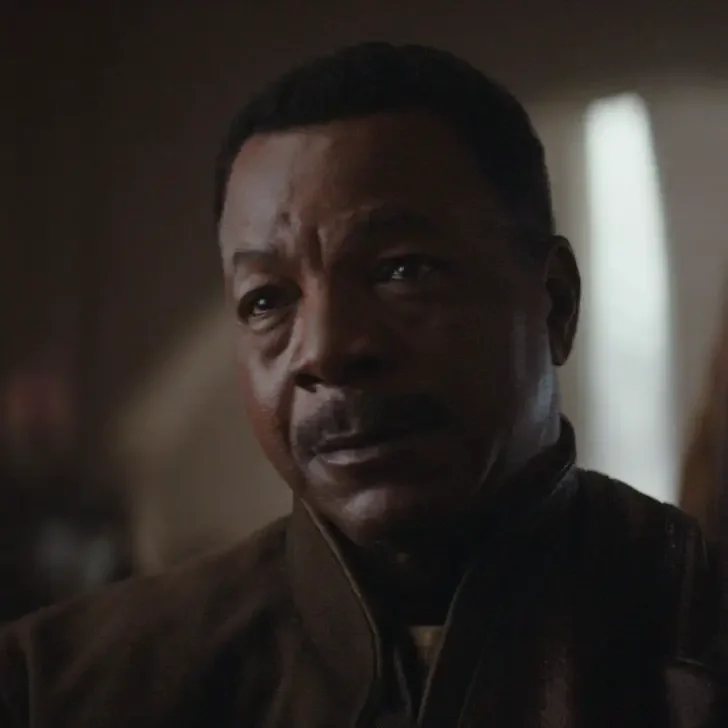 Photo still of a scene from season 1 of The Mandalorian featuring Greef Karga (Carl Weathers).