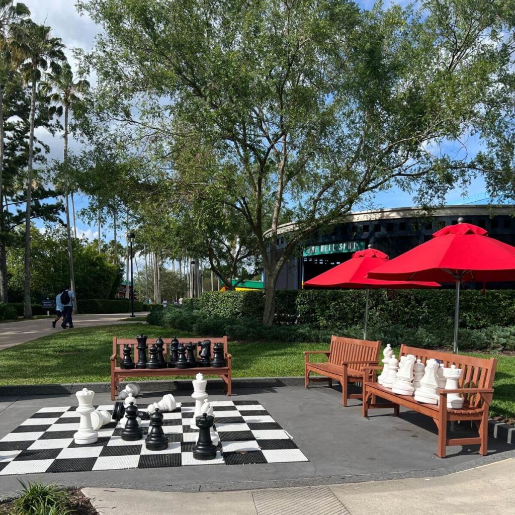 Photo of a life-sized chess set with pawns and benches nearby.