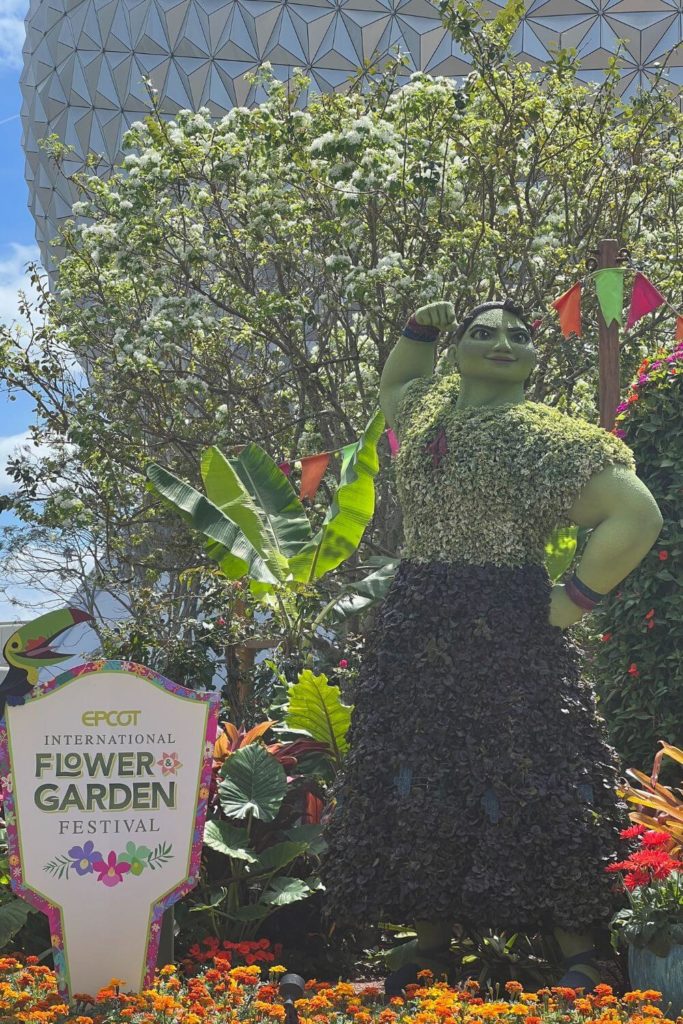 Photo of the Luisa Madrigal topiary outside the Epcot entrance.