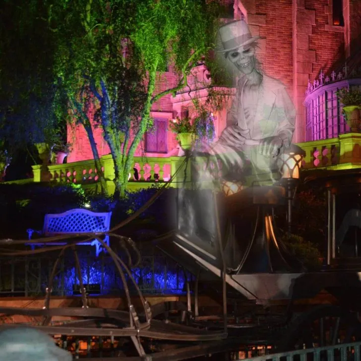 Example of a magic shot photo from MNSSHP with a hitchhiking ghost sitting on a prop with Haunted Mansion in the background.