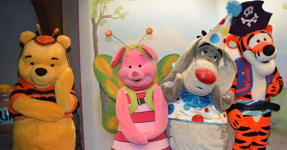 Photo of Winnie the Pooh, Piglet, Eeyore, and Tigger with Halloween costumes on.