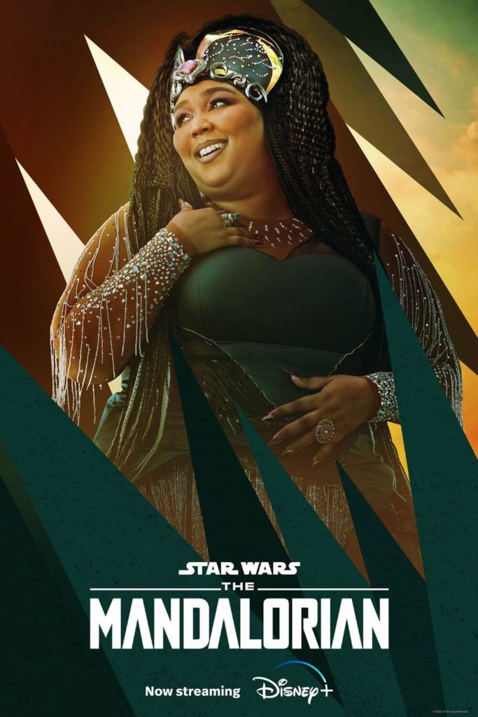 Promotional poster for season 3 of The Mandalorian featuring Lizzo as The Duchess. She is wearing a green gown with crystals and fringe, with an elaborate crown and long braided hair.