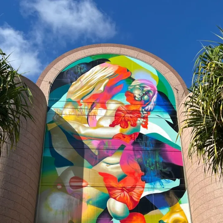 Photo of a massive, colorful street art mural at the Bishop Museum in Honolulu.