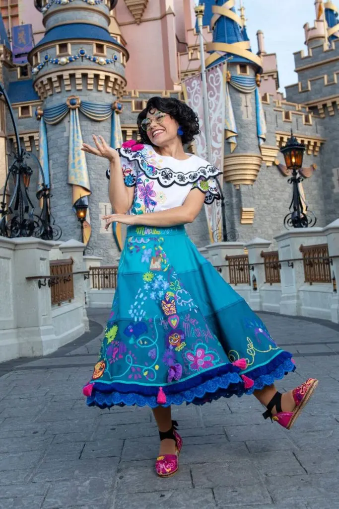 Photo of Mirabel from Encanto posing outside Cinderella's Castle at Magic Kingdom.