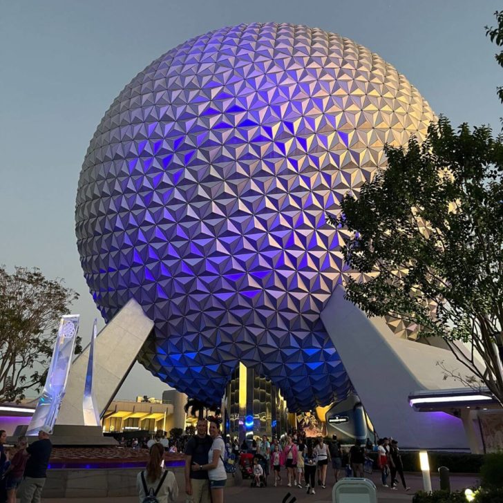 Photo of Spaceship Earth at dusk with blue lights.