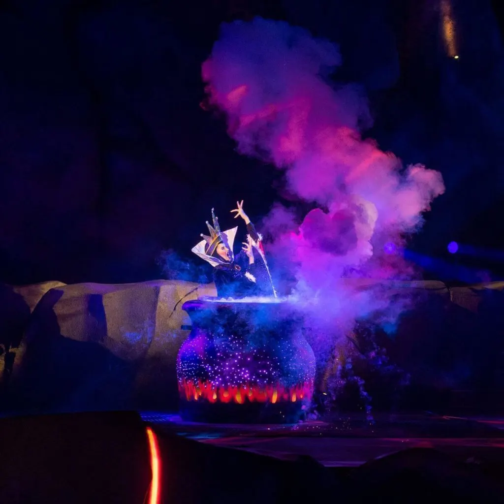 Photo of the Evil Queen performing in front of a large cauldron in Fantasmic! at Hollywood Studios.