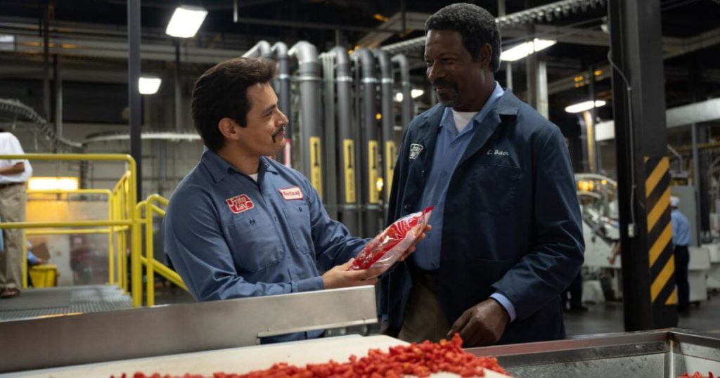 Photo still from the Disney movie based on a true story, Flamin' Hot, with Jesse Garcia and Dennis Haysbert.