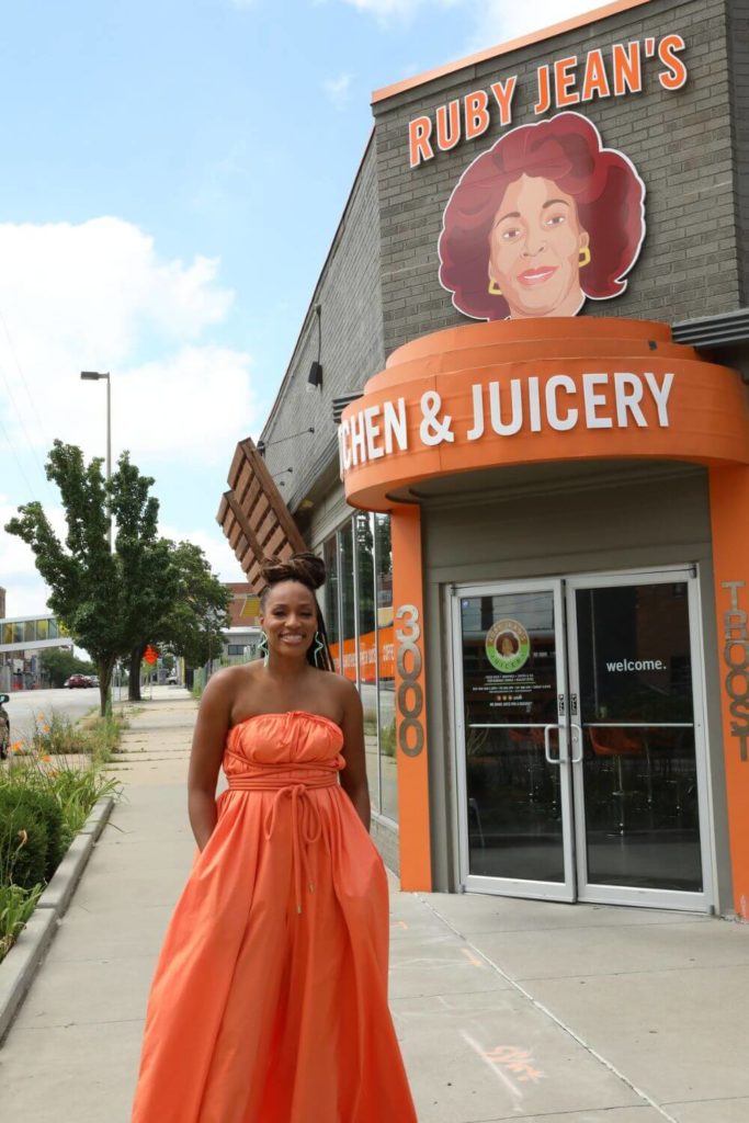 National Geographic host Martinique Lewis poses in front of Ruby Jean's Juicery in Kansas City, Mo.