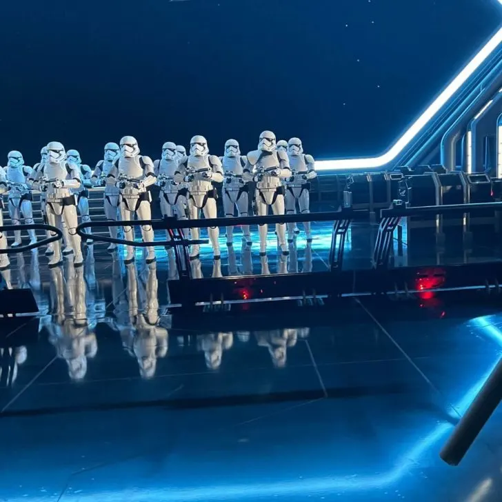 Photo of a large group of stormtroopers standing at the ready with their guns in hand and dark blue lighting on Rise of the Resistance at Star Wars: Galaxy's Edge in Hollywood Studios.