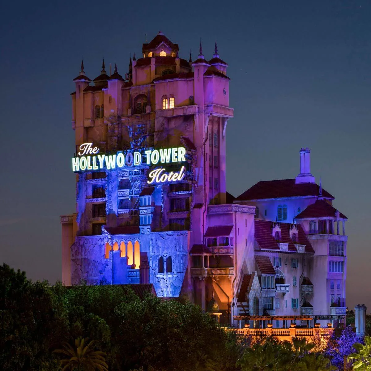 Photo of the Hollywood Tower Hotel Tower of Terror building at night.