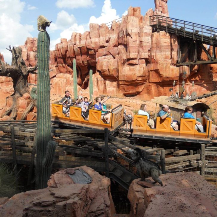 Photo of guests riding by on Big Thunder Mountain Railroad in Magic Kingdom.