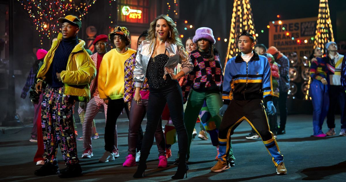 Mom, played by Allison Holker Boss (center), dances with ensemble members at the block party in Disney's The Hip Hop Nutcracker.