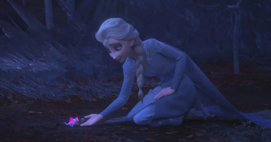 Photo still from Frozen 2 of Queen Elsa bending over to let Bruno the salamander into her hand, also featured in the Zenimation episode, Discovery.