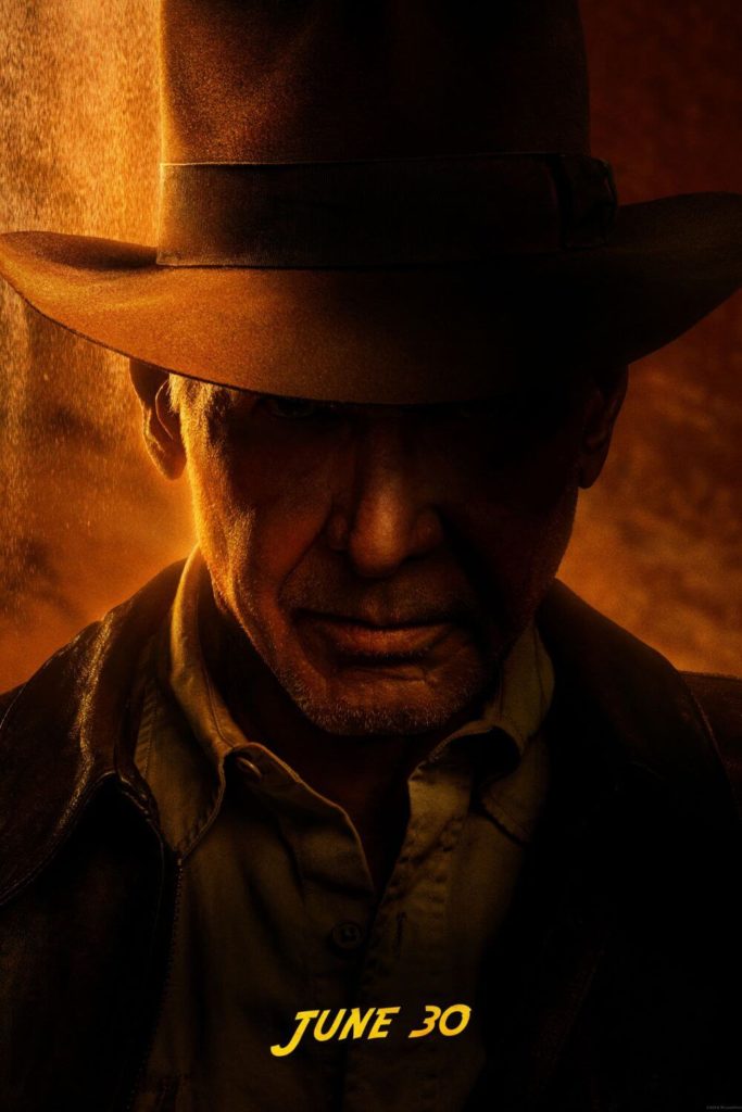 Closeup of Harrison Ford as Indiana Jones with his fedora-clad head tilted down. Text below the image says "June 30."