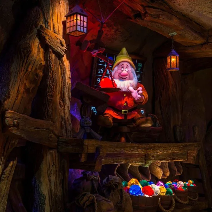 Photo of Doc weighing a ruby inside Seven Dwarfs Mine Train ride.