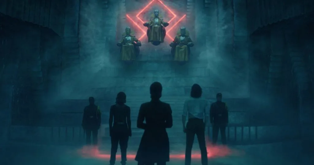 Promotional still from Loki, Season 1, Episode 4, featuring Loki (Tom Hiddleston), Sylvie (Sophia DiMartino), and Judge Renslayer (Gugu Mbatha-Raw) with their back to the camera. In the background are the 3 Timekeepers and 2 guards.