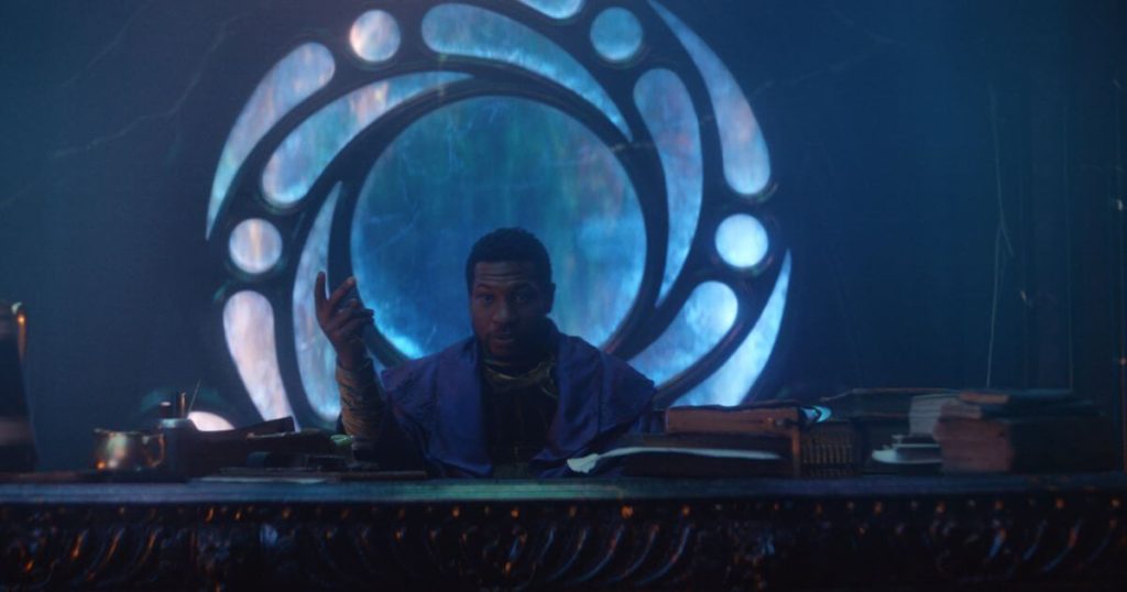 Promotional still from Loki, Season 1, Episode 6, featuring He Who Remains (Jonathan Majors) sitting at a desk.