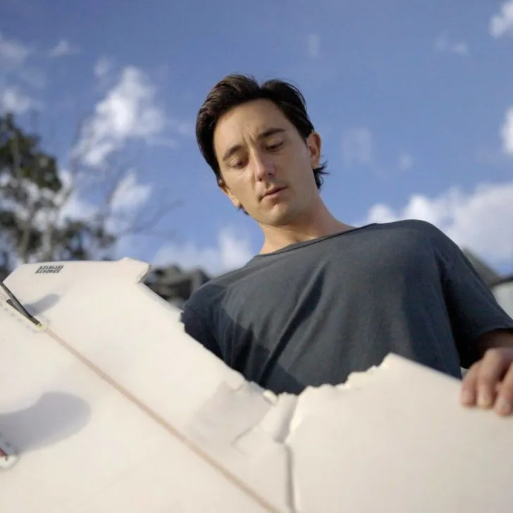 Shark attack survivor Mike Bruton with his surfboard that he was riding when he was attacked in New South Wales, Australia.