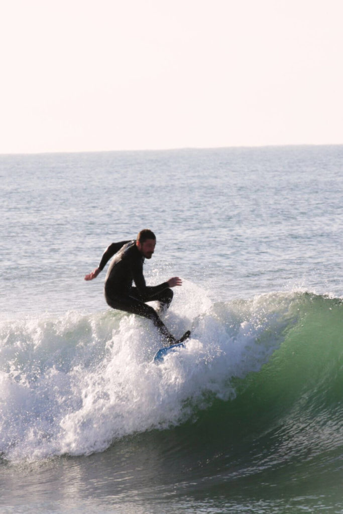 Dustin Philips surfing a wave at San Onofre Beach.