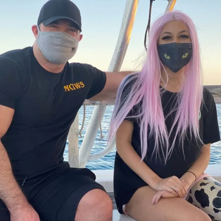 Photo of Paige Winter posing with her dad on a boat.