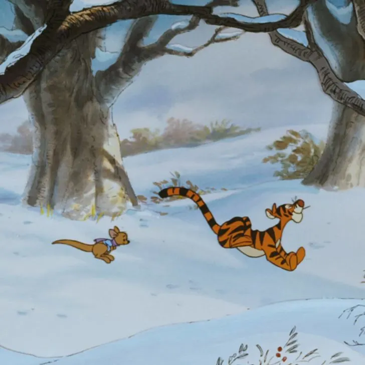 Photo still of Tigger and Roo bouncing through the snow.