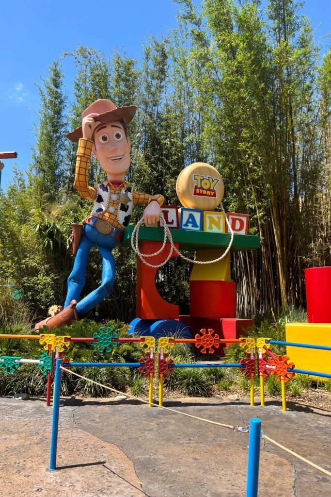 Photo of the main entrance of Toy Story land showing the sign and giant Woody statue.
