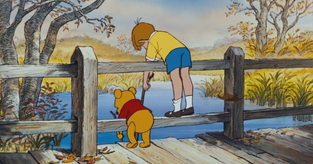 Photo still from Winnie the Pooh, with Pooh and Christopher Robin leaning over a fence, fishing in a pond, as featured in the Zenimation episode, Water Realms.