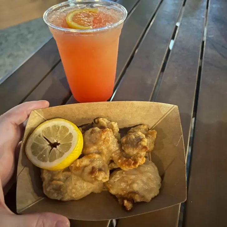 Photo of Japanese friend chicken and a orange cocktail from Ye Sake.