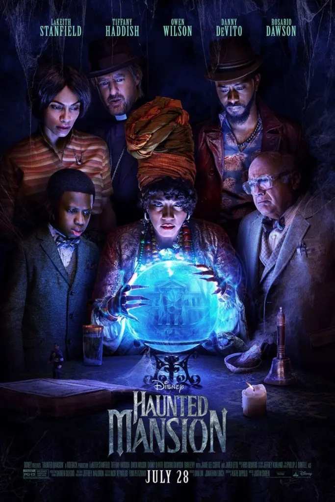 Promotional poster for Disney's Haunted Mansion with the cast posing around a large crystal ball.