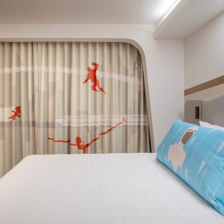 Photo of the new Incredibles rooms at Disney's Contemporary Resort, with Frozone pillowcase and Incredibles curtains.