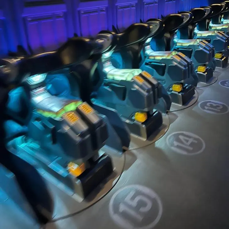 Photo of the Flight of Passage ride seats with numbers in front of each one.