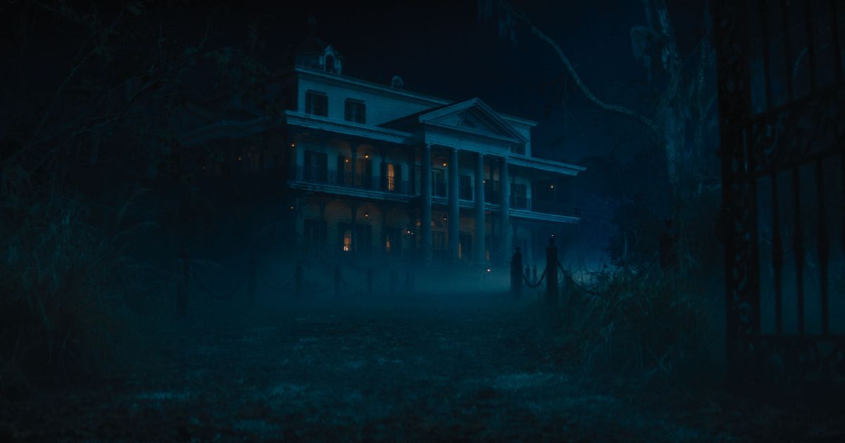 Photo still from the 2023 Disney film, Haunted Mansion, showing the mansion at night.