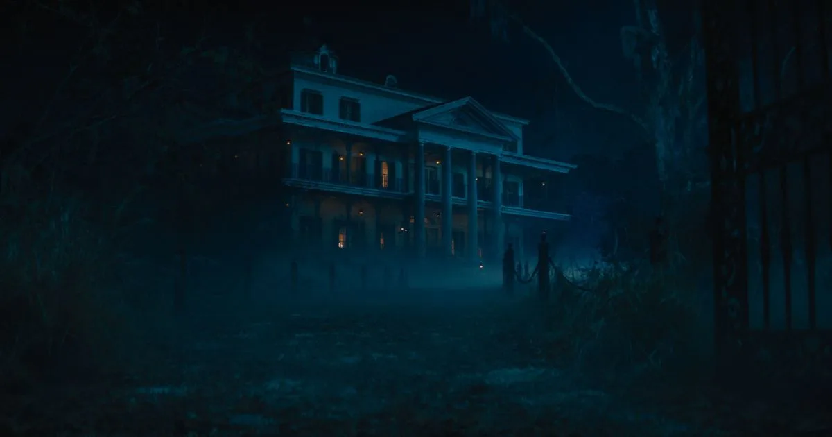Photo still from the 2023 Disney film, Haunted Mansion, showing the mansion at night.