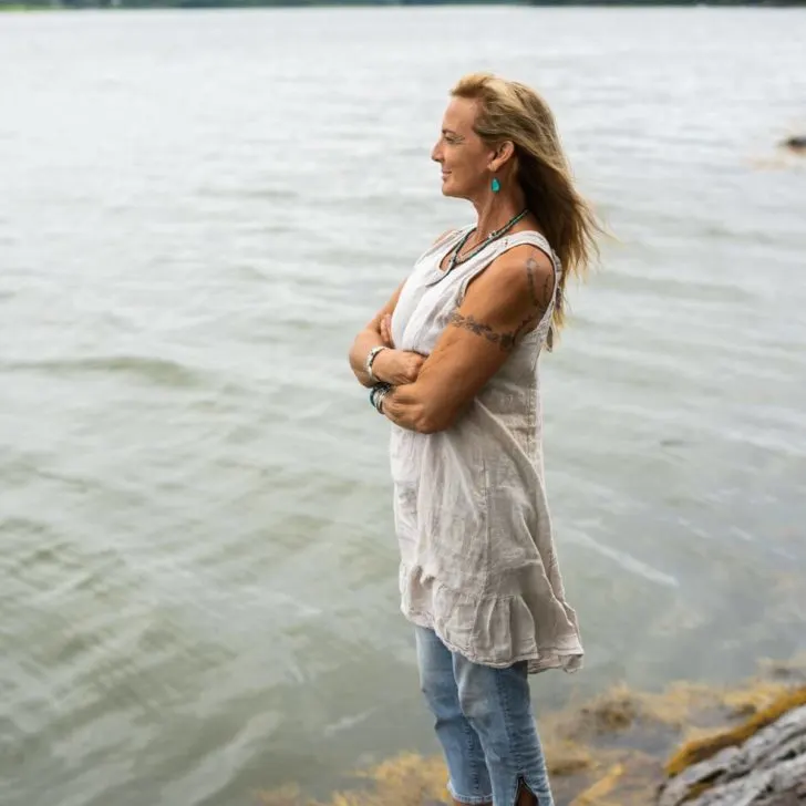 Marine biologist and whale expert Nan Hauser standing by the shoreline.