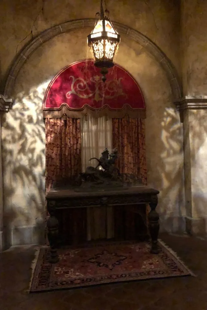 Photo of a dimly light corner inside the Hollywood Tower Hotel with cobwebs and creepy statues.
