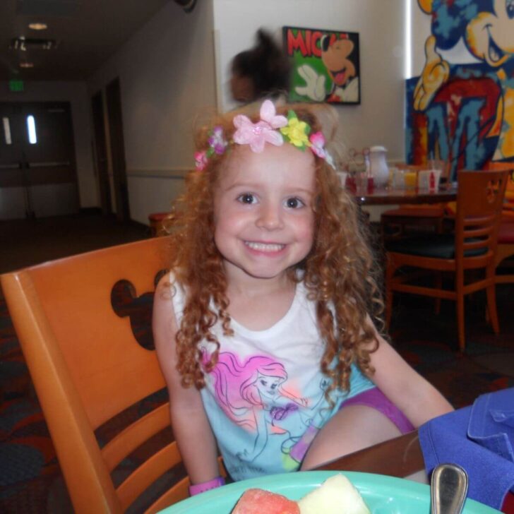 Photo of a toddler posing happily at Chef Mickey's character meal at the Contemporary Resort.