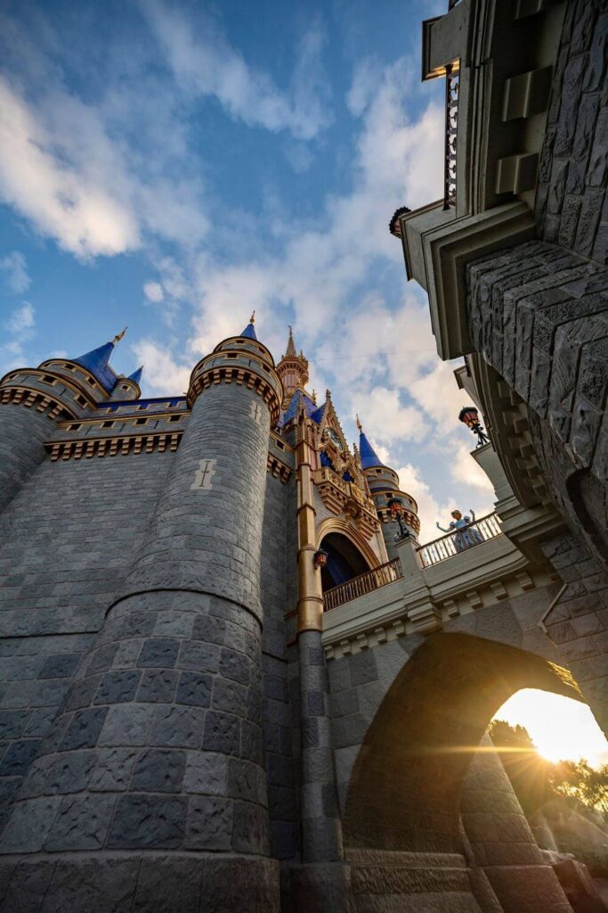 Photo of Cinderella posing outside her castle at Magic Kingdom during sunrise.